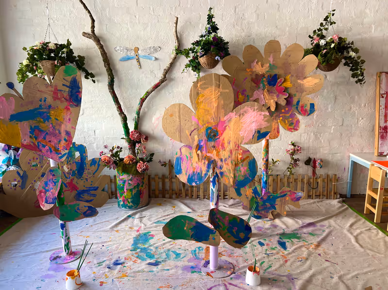 Giant painted cardboard flowers built during a Smudge Artspace holiday program