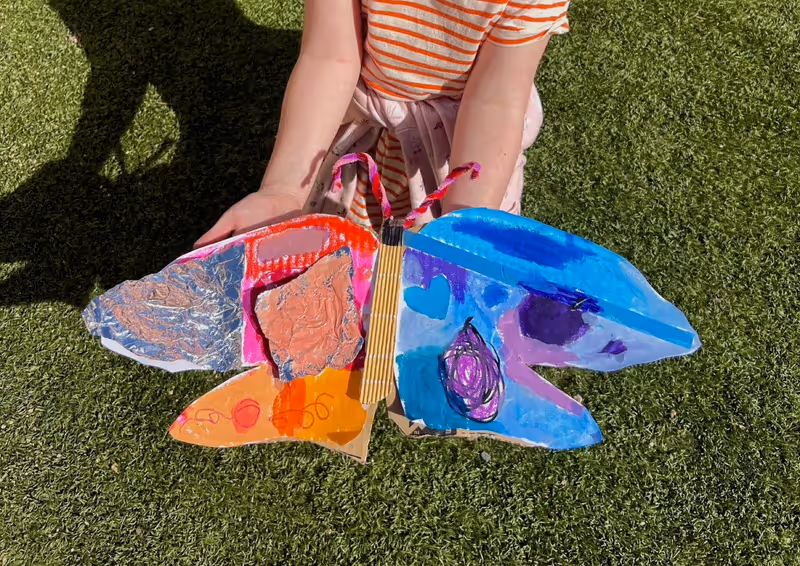 A giant painted cardboard butterfly made at a Smudge party